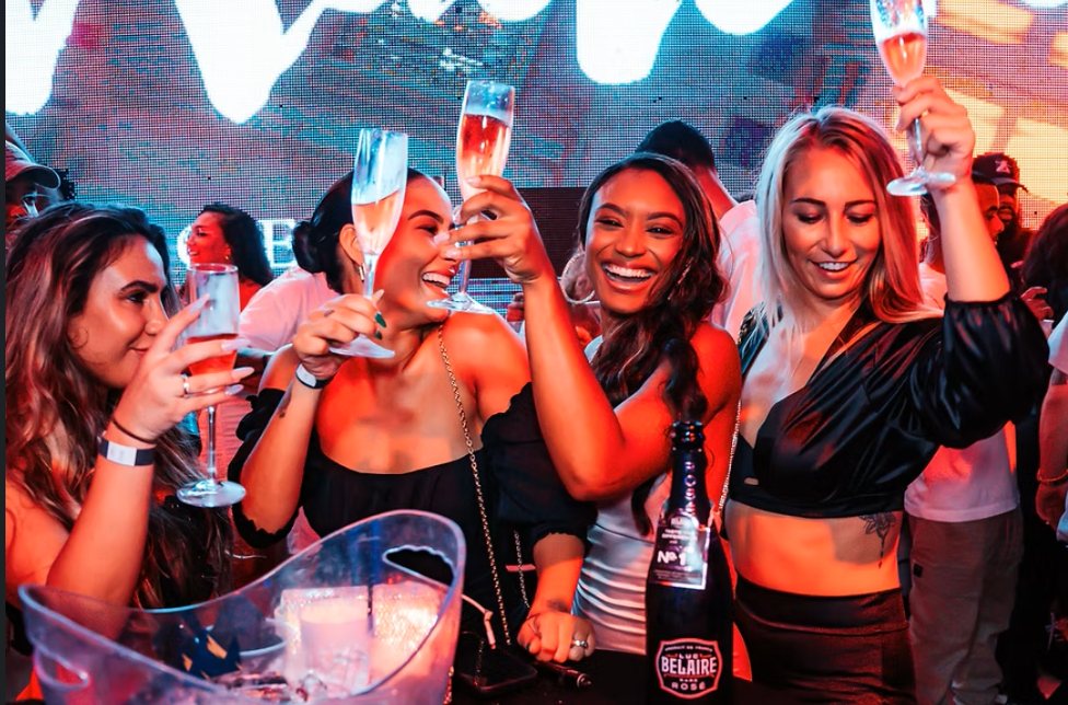 Crowd toasting at Madero Ocean Club, Mambo Beach